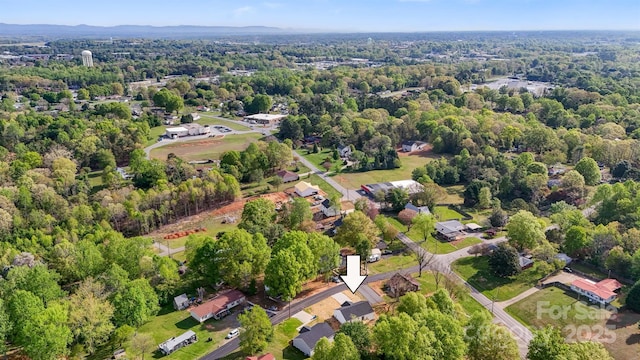 birds eye view of property featuring a view of trees