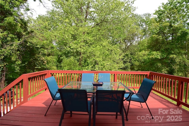 wooden terrace with outdoor dining space