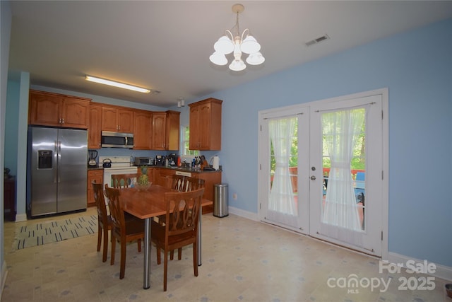dining area featuring visible vents, a healthy amount of sunlight, a notable chandelier, and french doors