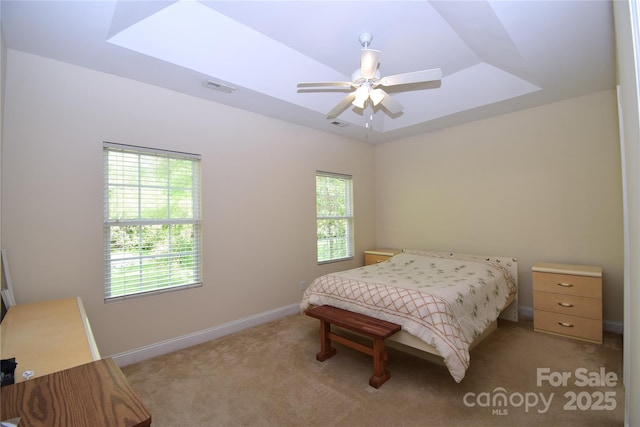 bedroom with ceiling fan, light carpet, visible vents, and baseboards