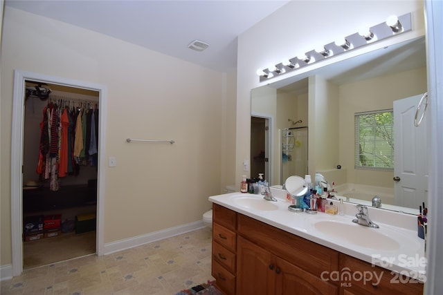 full bathroom with a bath, a sink, a shower stall, and double vanity