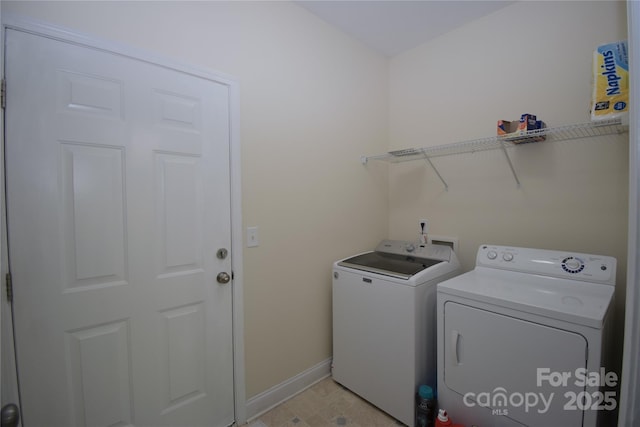 laundry area with baseboards, independent washer and dryer, and laundry area