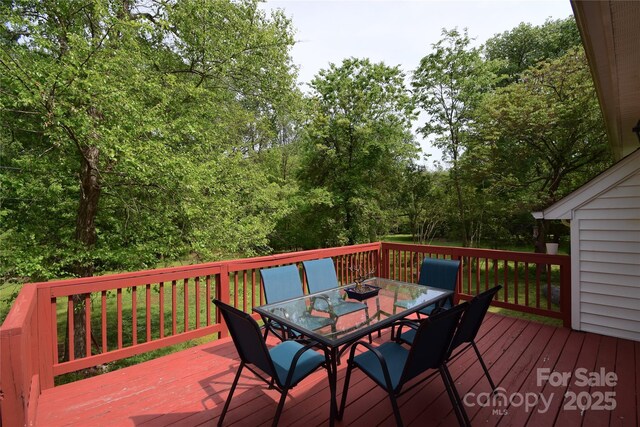 wooden terrace featuring outdoor dining space