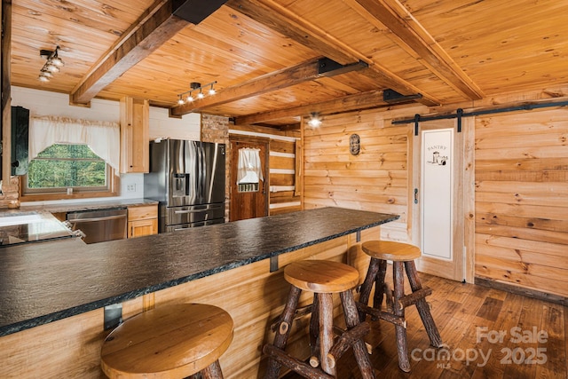 kitchen with wood ceiling, beam ceiling, and appliances with stainless steel finishes