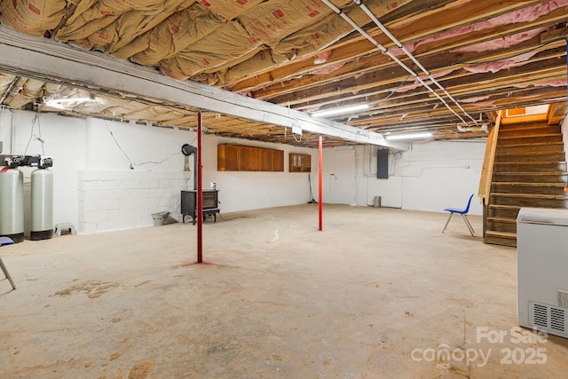 unfinished below grade area with stairway and electric panel