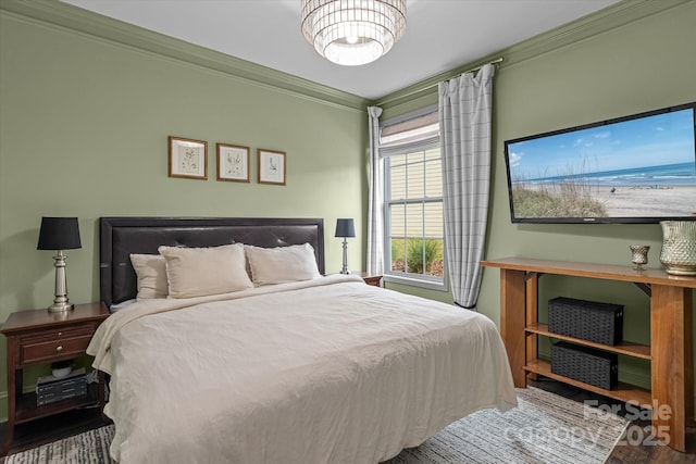 bedroom featuring wood finished floors and crown molding