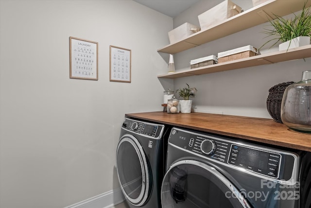 laundry area featuring washing machine and clothes dryer and laundry area