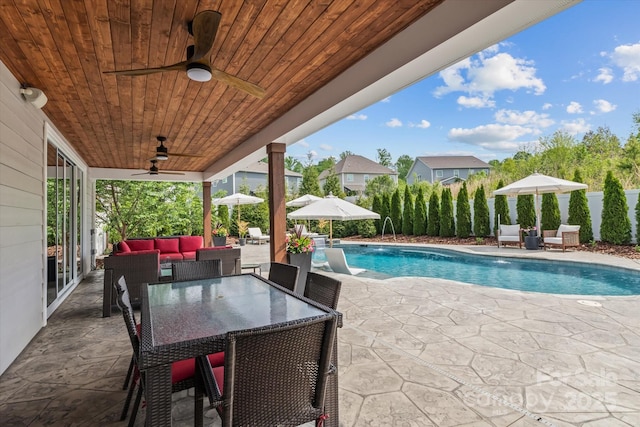 view of swimming pool featuring a fenced backyard, ceiling fan, a fenced in pool, a patio, and outdoor lounge area