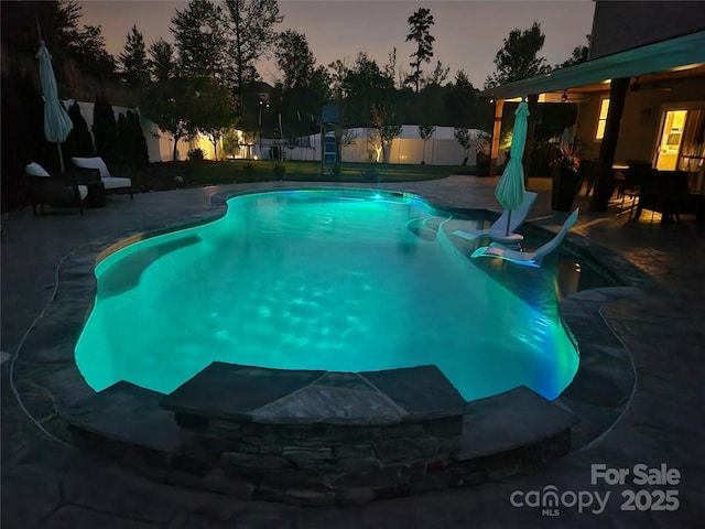 view of swimming pool with a fenced in pool, a fenced backyard, and a patio area