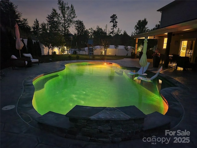 view of pool with ceiling fan, a fenced backyard, a fenced in pool, and a patio area