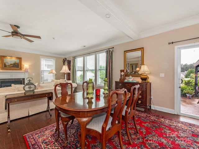79044 Ridgehaven Rd, Lancaster, SC 29720 - dining room featuring dark wood-type flooring, ceiling fan, crown molding, baseboards, and a glass covered fireplace