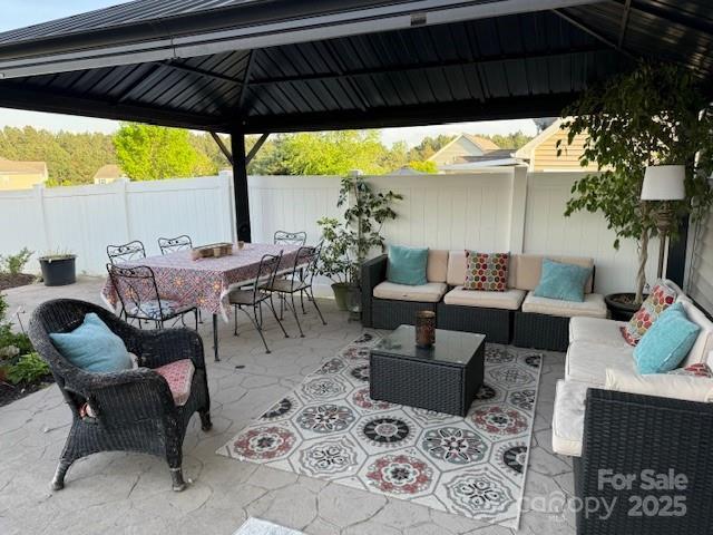 79044 Ridgehaven Rd, Lancaster, SC 29720 - fenced backyard featuring a gazebo, outdoor lounge area, outdoor dining area, and a patio