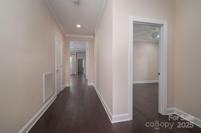 corridor with baseboards, recessed lighting, ornamental molding, dark wood-style floors, and visible vents