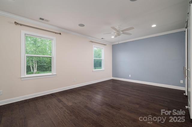 spare room with crown molding, ceiling fan, baseboards, dark wood-style flooring, and visible vents