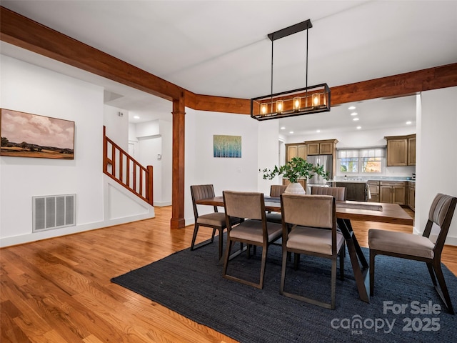 dining room featuring beamed ceiling, recessed lighting, stairway, light wood-style floors, and visible vents