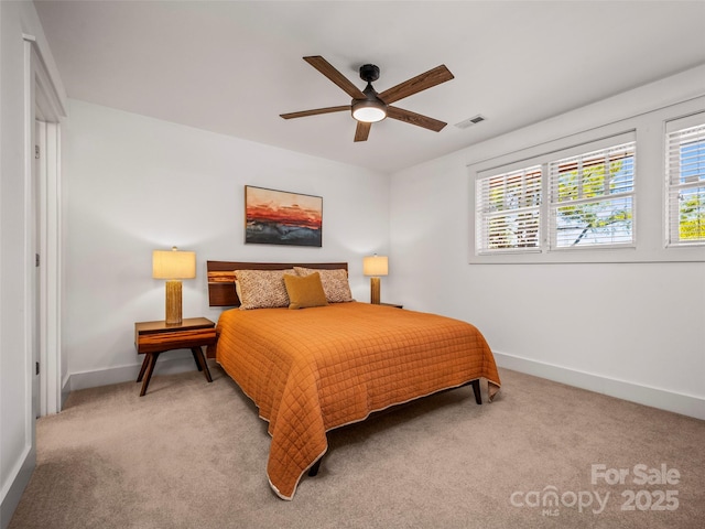 carpeted bedroom with baseboards, visible vents, and ceiling fan