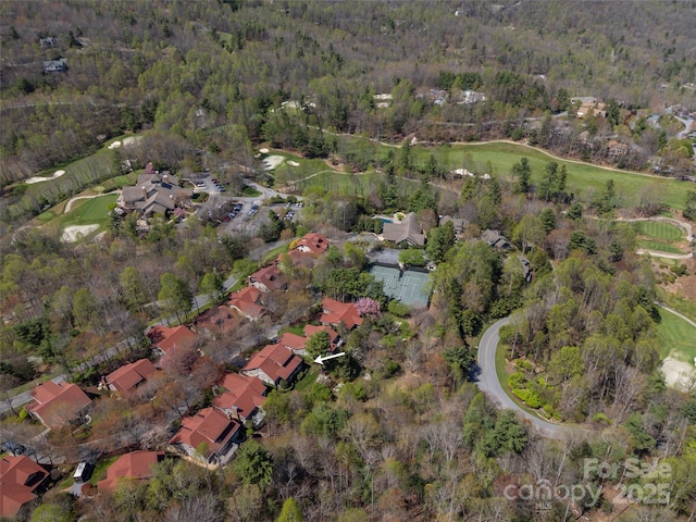 birds eye view of property with a forest view, a residential view, and view of golf course
