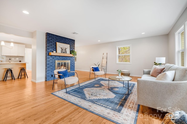 16 Graystone Rd, Asheville, NC 28804 - living room featuring visible vents, a fireplace, baseboards, light wood-style floors, and recessed lighting