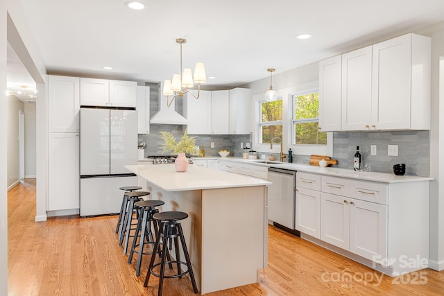 16 Graystone Rd, Asheville, NC 28804 - kitchen with a sink, dishwasher, a kitchen breakfast bar, freestanding refrigerator, and custom exhaust hood