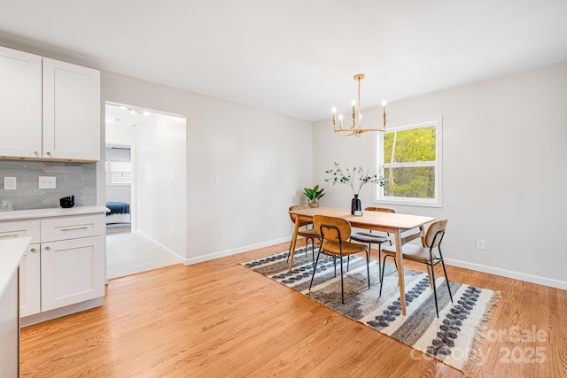 16 Graystone Rd, Asheville, NC 28804 - dining room with baseboards, an inviting chandelier, and light wood-style flooring