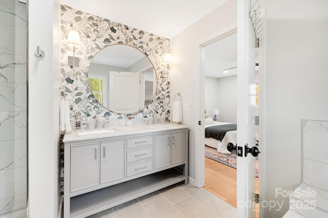 16 Graystone Rd, Asheville, NC 28804 - ensuite bathroom featuring double vanity, tasteful backsplash, a sink, and ensuite bath
