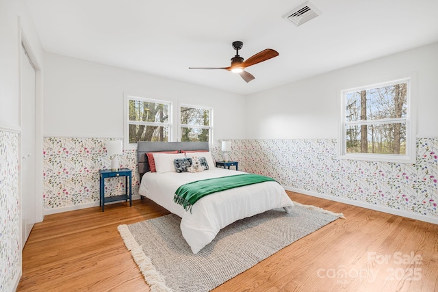 16 Graystone Rd, Asheville, NC 28804 - bedroom with wallpapered walls, visible vents, a wainscoted wall, and light wood-style floors