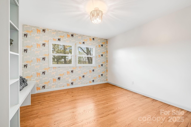 16 Graystone Rd, Asheville, NC 28804 - spare room with an inviting chandelier, baseboards, light wood finished floors, and wallpapered walls
