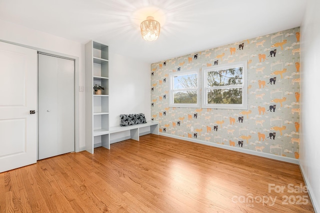 16 Graystone Rd, Asheville, NC 28804 - unfurnished bedroom featuring wallpapered walls, baseboards, and light wood finished floors
