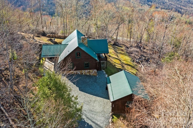 birds eye view of property featuring a view of trees