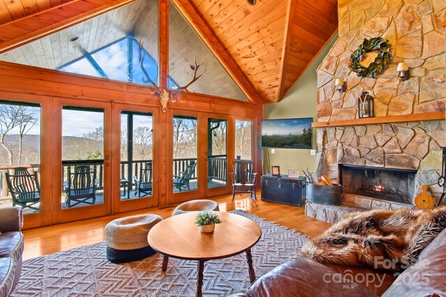 living area featuring wood finished floors, wood ceiling, and plenty of natural light