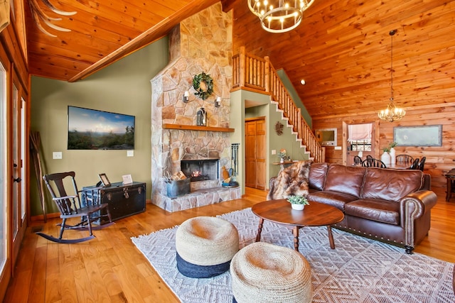 living area featuring wooden ceiling, wood finished floors, a chandelier, and stairway
