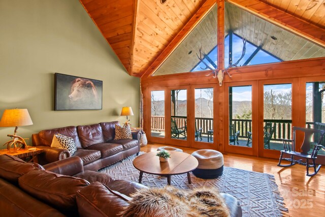 living room featuring wood ceiling, beam ceiling, wood finished floors, and high vaulted ceiling