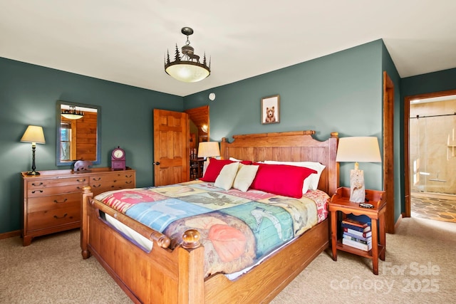 bedroom featuring baseboards, ensuite bathroom, and carpet flooring