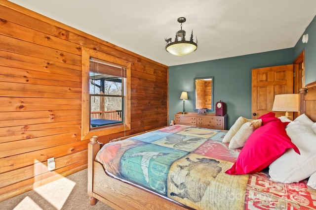 bedroom featuring wooden walls and carpet flooring