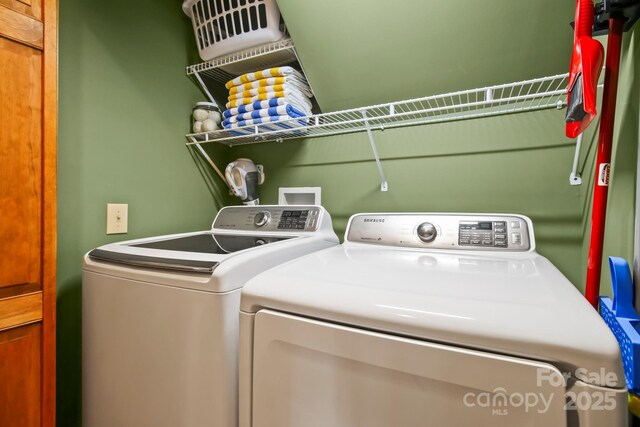laundry area featuring washing machine and clothes dryer and laundry area