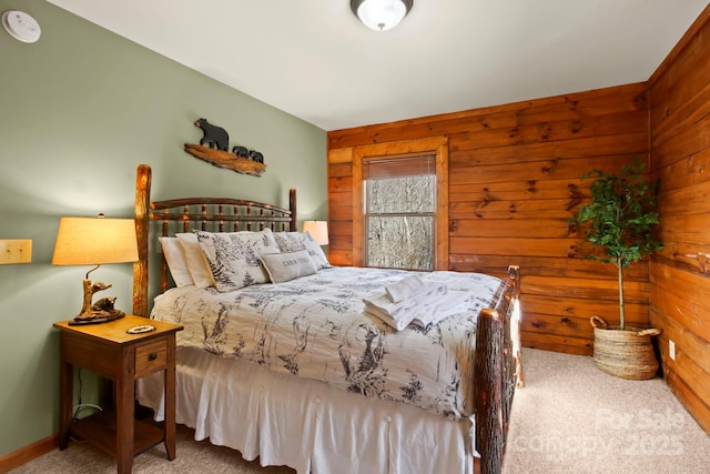 carpeted bedroom with wooden walls