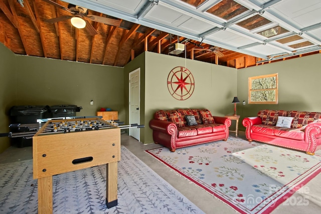 playroom featuring concrete floors, a ceiling fan, and a garage