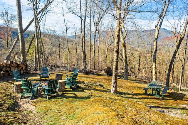 view of yard with a fire pit and a mountain view