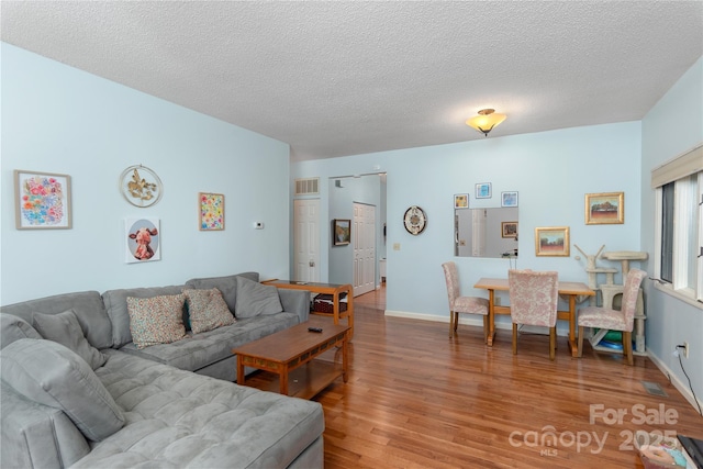 305 Piney Mountain Dr Unit R1, Asheville, NC 28805 - living area featuring light wood-style floors, a textured ceiling, and baseboards