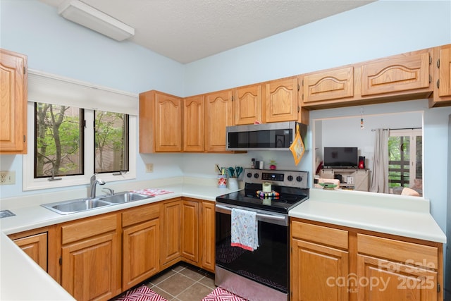 305 Piney Mountain Dr Unit R1, Asheville, NC 28805 - kitchen with stainless steel appliances, a sink, light countertops, and dark tile patterned floors