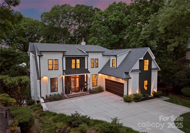 3933 Ayrshire Pl, Charlotte, NC 28210 - modern inspired farmhouse with roof with shingles, stucco siding, a chimney, a standing seam roof, and concrete driveway