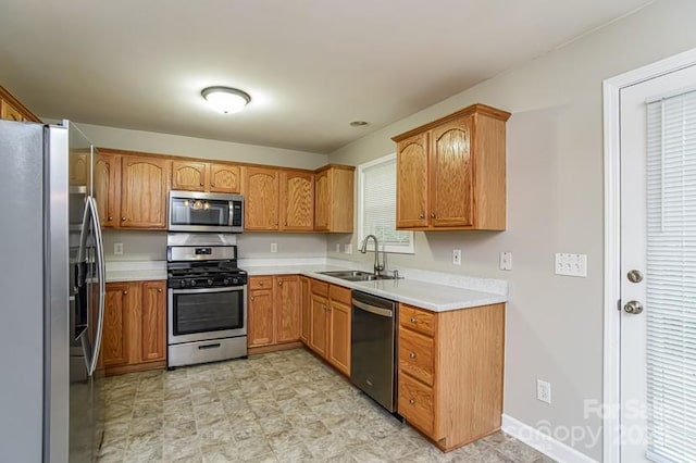 1930 Manning Pl, Rock Hill, SC 29730 - kitchen with a sink, appliances with stainless steel finishes, brown cabinetry, and light countertops