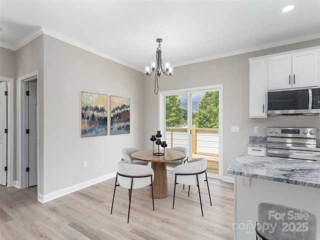 21 Kathy Dr, Waynesville, NC 28786 - dining room with light wood-style flooring, a chandelier, ornamental molding, and baseboards