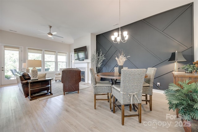 3029 Trace Meadow Ct, York, SC 29745 - dining area featuring light wood finished floors, visible vents, a decorative wall, and ceiling fan with notable chandelier