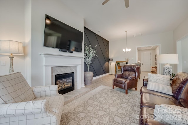 3029 Trace Meadow Ct, York, SC 29745 - living room with a fireplace, ceiling fan with notable chandelier, light wood-type flooring, and visible vents
