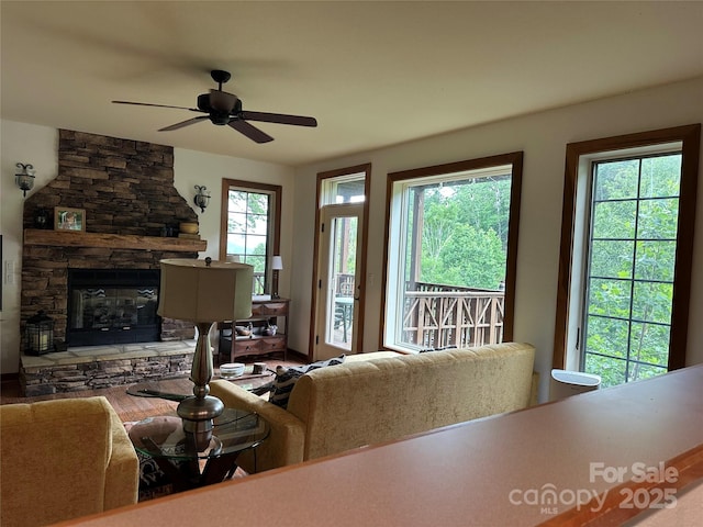 222 Creekside Way, Burnsville, NC 28714 - living area featuring a ceiling fan and a stone fireplace