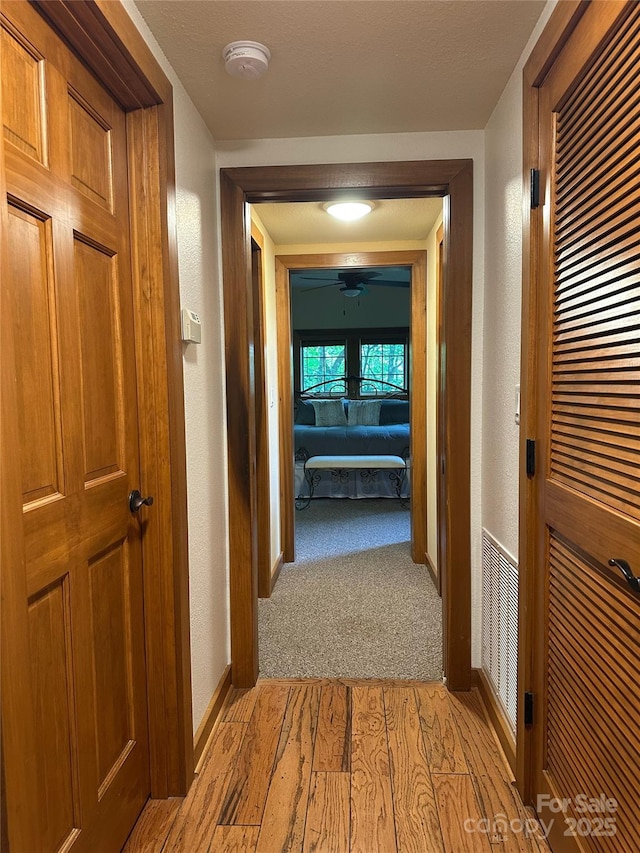 222 Creekside Way, Burnsville, NC 28714 - hall with light wood finished floors and a textured wall