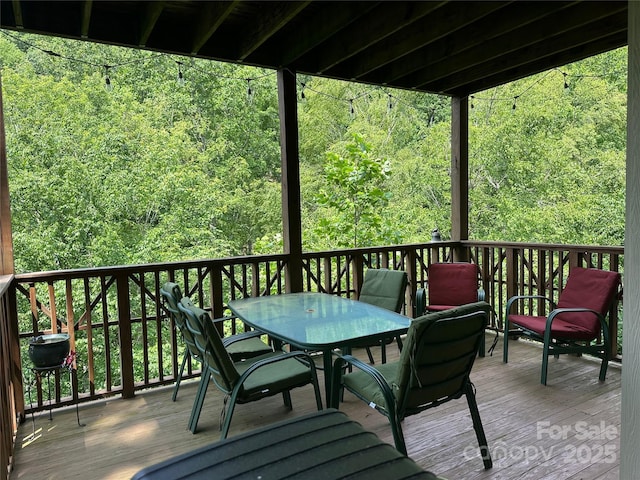 222 Creekside Way, Burnsville, NC 28714 - deck featuring outdoor dining area and a view of trees