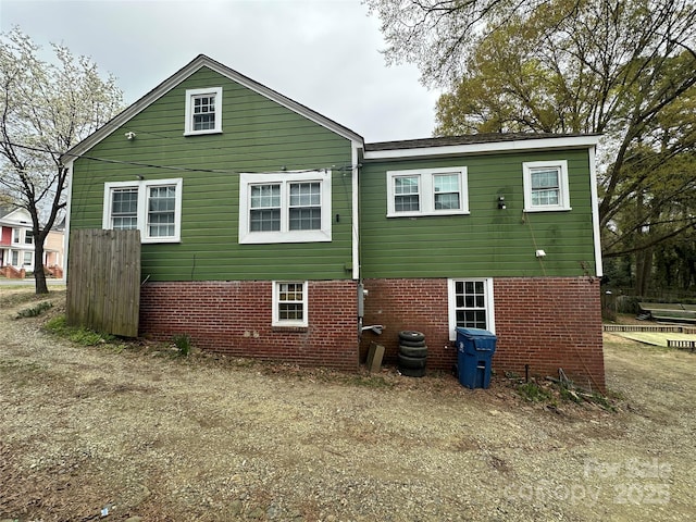 rear view of house with brick siding