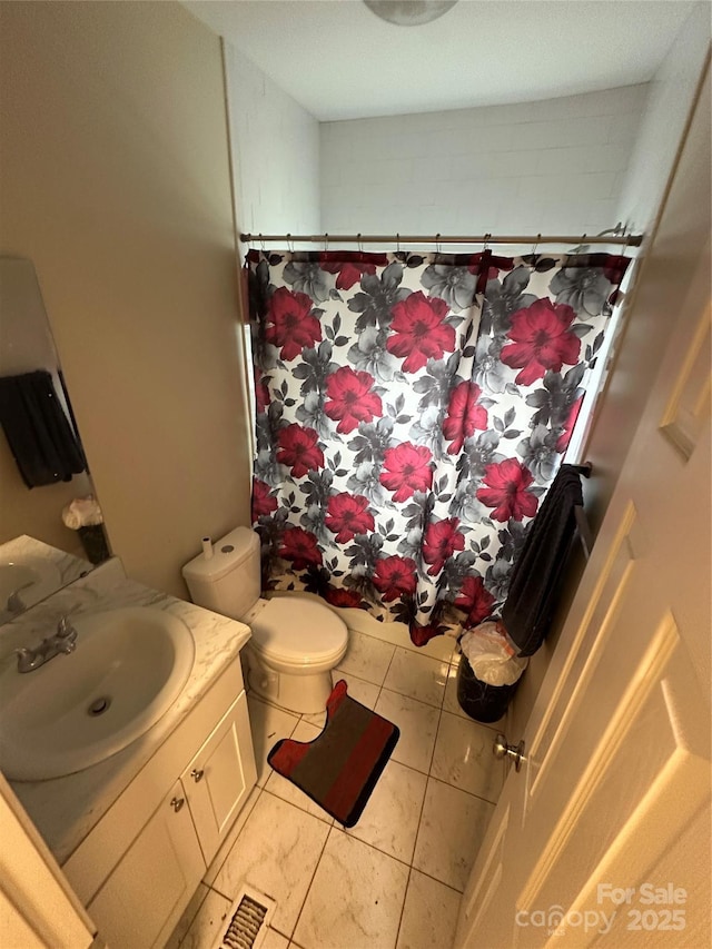 bathroom featuring vanity, tile patterned flooring, toilet, and a shower with curtain